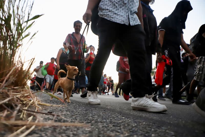 Migrants walk in a caravan as an attempt to reach the U.S. border, in Arriaga