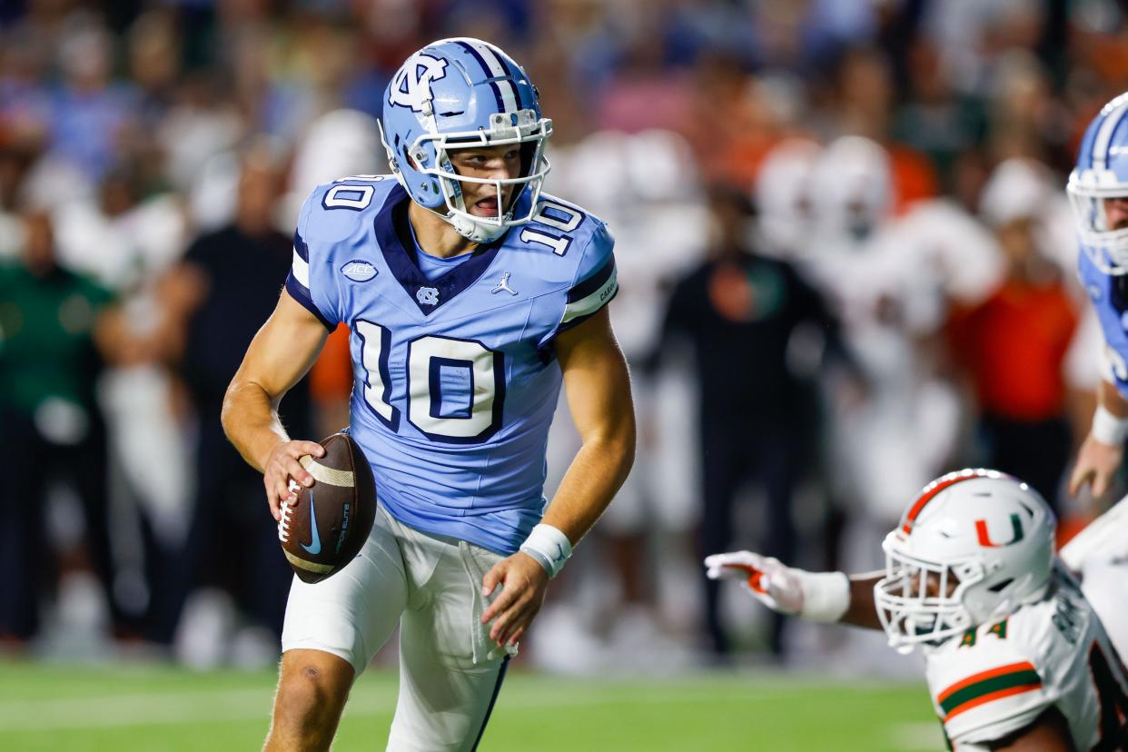 Oct 14, 2023; Chapel Hill, North Carolina, USA; North Carolina Tar Heels quarterback Drake Maye (10) runs against the Miami Hurricanes in the first half at Kenan Memorial Stadium. Mandatory Credit: Nell Redmond-USA TODAY Sports