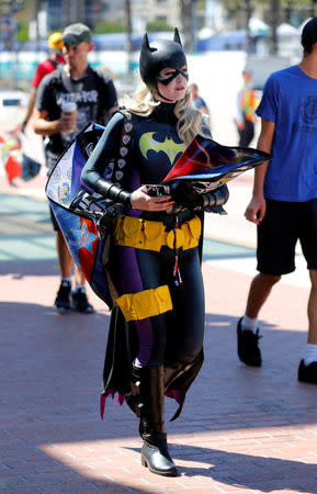 An attendee dressed as Bat Girl arrives for the start of Comic-Con International in San Diego, California, United States, July 20, 2016. REUTERS/Mike Blake