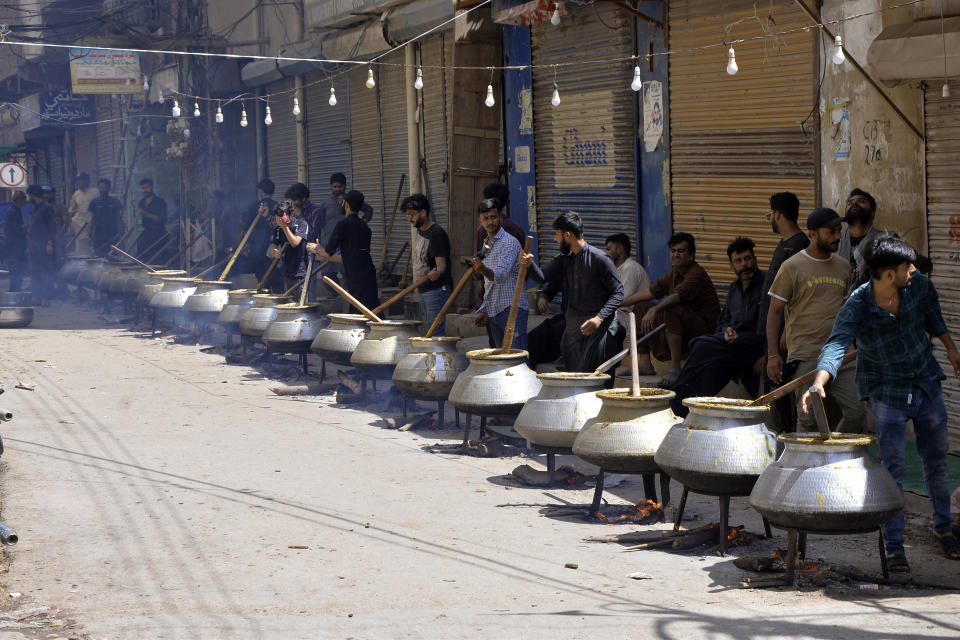 Devotees prepare food for Shiite Muslims on the 9th day of Muharram, in Hyderabad, Pakistan, Friday, July 28, 2023. Ashoura is the Shiite Muslim commemoration marking the death of Hussein, the grandson of the Prophet Muhammad, at the Battle of Karbala in present-day Iraq in the 7th century.(AP Photo/Pervez Masih)