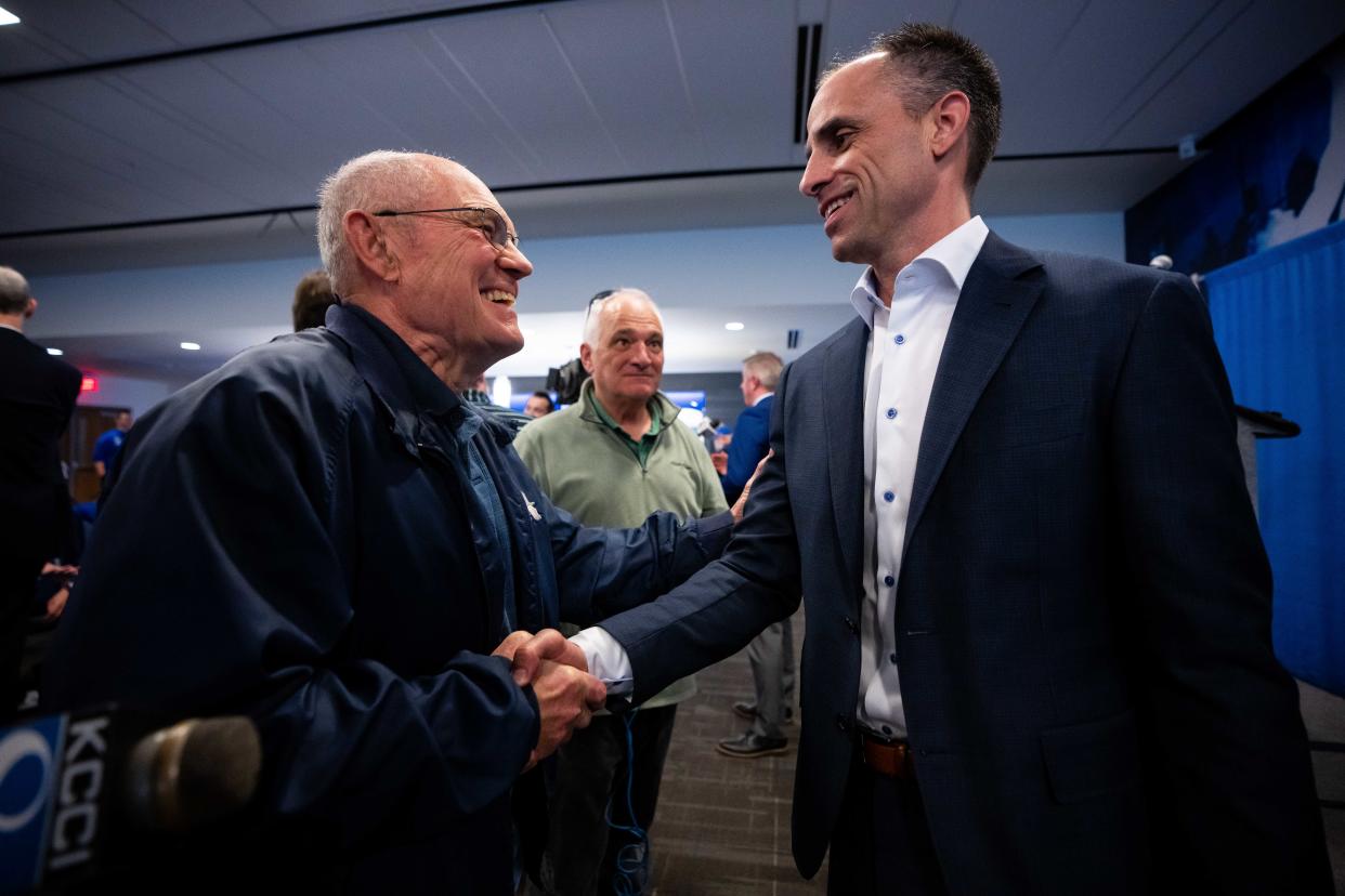 Ben McCollum, the new head coach of Drake Men's Basketball, meets with long time Northwest Missouri State fan Dennis Bunch during his introductory press conference Tuesday, April 9, 2024, at the Knapp Center in Des Moines.