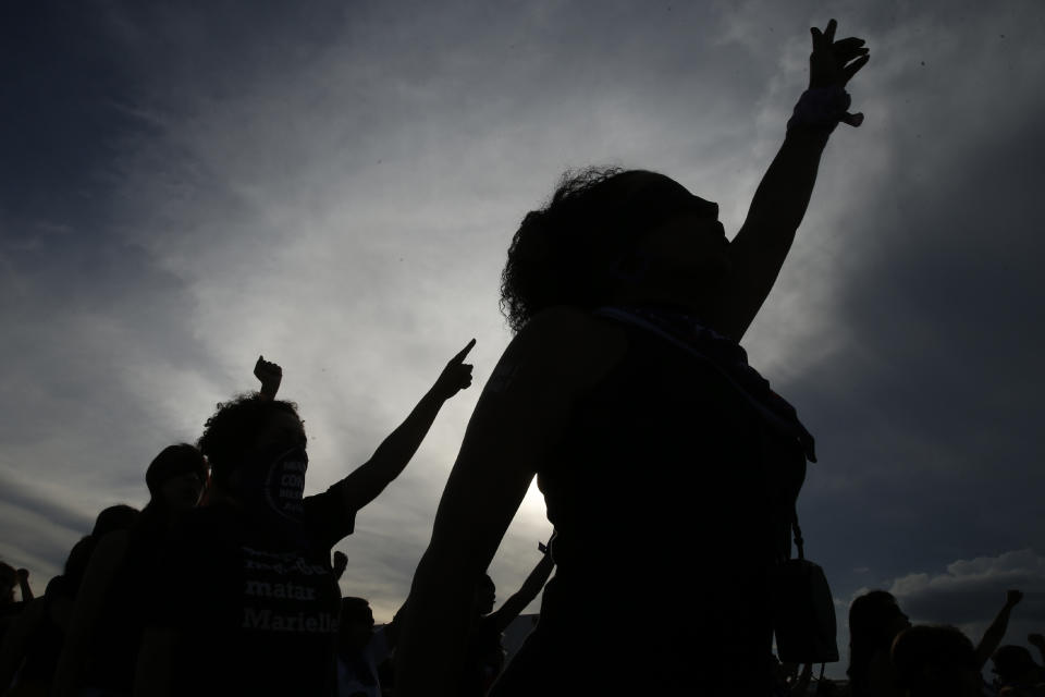 Women perform the feminist anthem "A rapist in your path," in a demonstration against gender-based violence, in front of the Supreme Court, in Brasilia, Brazil, Friday, Dec. 13, 2019. (AP Photo/Eraldo Peres)