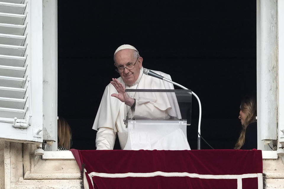Pope Francis waves at the end of the Angelus noon prayer from the window of his studio overlooking St. Peter's Square, at the Vatican, Sunday, Oct. 23, 2022. (AP Photo/Alessandra Tarantino)