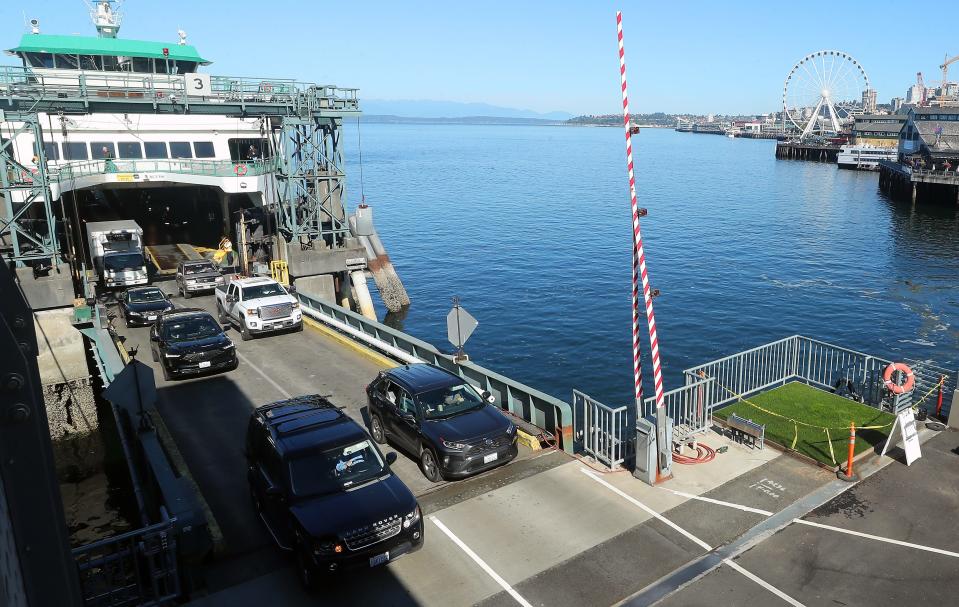 Cars exit the ferry Tacoma and pass a small patch of grass that was installed and tended to by Allen Daniel, a Seattle resident and traffic attendant for Washington State Ferries, at Colman Dock in Seattle on Wednesday, Aug. 2, 2023.