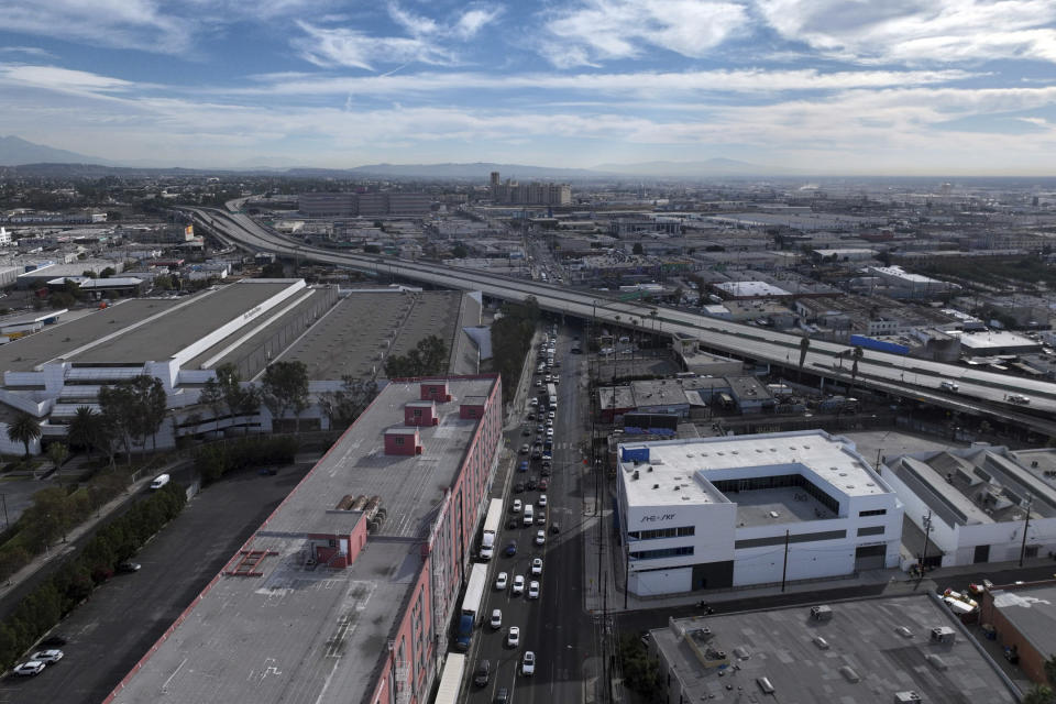 In this aerial view, traffic is backed up under a closed interstate 10 in the aftermath of a fire, Monday, Nov. 13, 2023, in Los Angeles. Los Angeles drivers are being tested in their first commute since a weekend fire that closed a major elevated interstate near downtown. (AP Photo/Jae C. Hong)