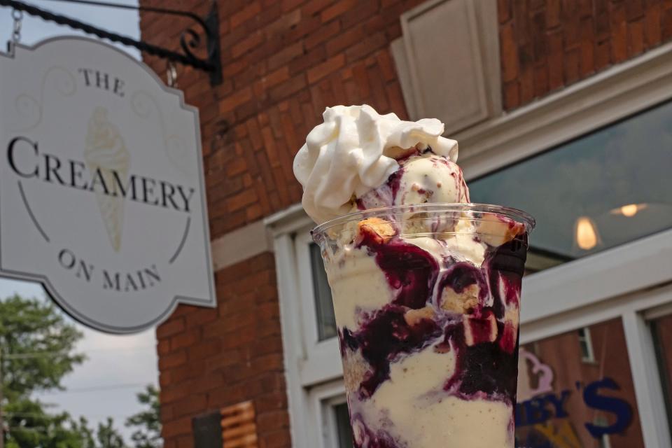 Parfait layered with Lemon Cheesecake Bar ice cream, blueberry sauce, cheesecake nibbles and topped with whipped cream at The Creamery on Main in Armada, Mich., on July 16, 2023. The shop sells Michigan-based Ashby’s Sterling Ice Cream.