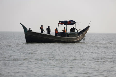 Bangladesh coast guards sail in a vessel, near the Thengar Charan island in the Bay of Bengal, Bangladesh, February 2, 2017. Picture taken February 2, 2017. REUTERS/Mohammad Ponir Hossain