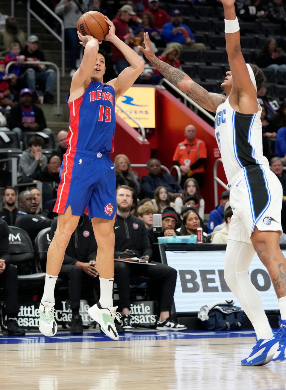 Detroit Pistons forward Simone Fontecchio (19) attempts a three-point basket as Orlando Magic forward Paolo Banchero defends during the first half at Little Caesars Arena in Detroit on Saturday, Feb. 24, 2024.