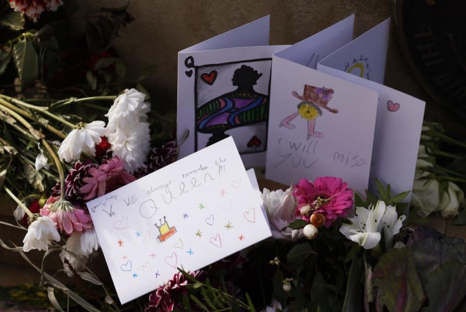 Flowers and messages are laid by a statue of Britain's Queen Elizabeth, on the day of the state funeral and burial of Britain's Queen Elizabeth, in Runnymede, Britain, September 19, 2022.