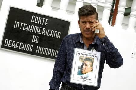 Jaime Alvarado, displays a portrait of his brother Jose Angel Alvarado, who went missing in 2009, allegedly as a result of human rights violations by the Mexico military, during a hearing convened by the judges of the Inter-American Court of Human Rights in San Jose, Costa Rica April 26, 2018. REUTERS/Juan Carlos Ulate