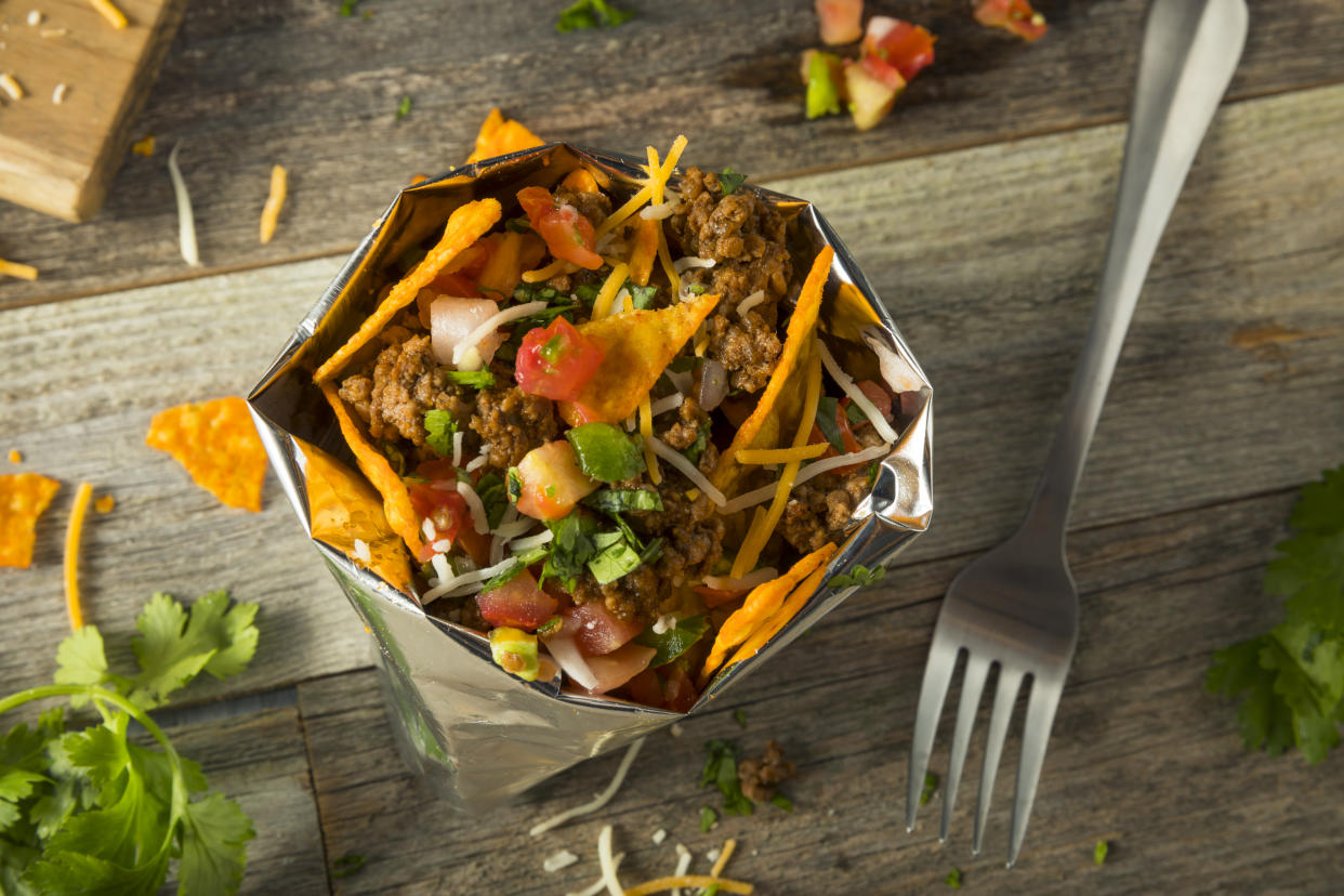 Walking tacos, tacos served inside corn chip snack bags, are a perfect way to make taco night more exciting. (Photo: Getty Creative)