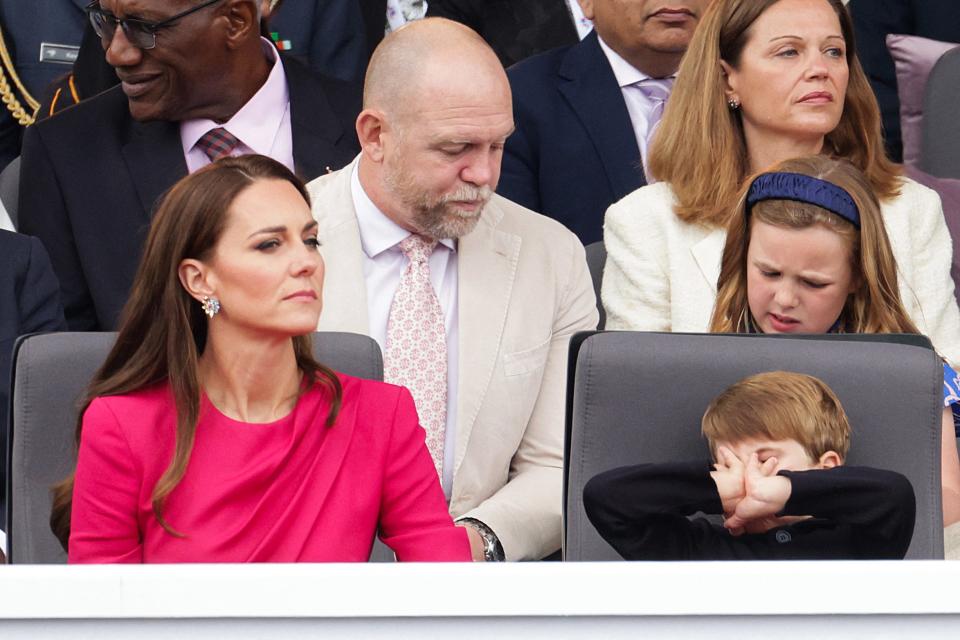 Kate Middleton looks on as Prince Louis covers his face with his hands