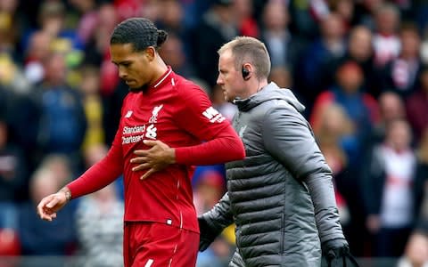 Liverpool's Virgil van Dijk leaves the pitch with an injury during the Premier League match at Anfield - Credit: Dave Thompson/PA