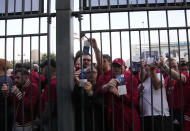 Liverpool fans wait in front of the of the Stade de France prior the Champions League final soccer match between Liverpool and Real Madrid, in Saint Denis near Paris, Saturday, May 28, 2022. (AP Photo/Christophe Ena)