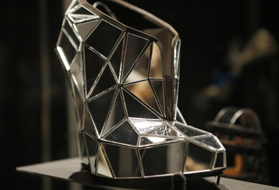 This Feb. 11, 2013 photo shows a shoe, made of mirror fragments titled "Invisible", designed by Andreia Chaves, displayed at the "Shoe Obsession" exhibit at The Museum at the Fashion Institute of Technology Museum in New York. The exhibition, showing off 153 specimens, runs through April 13. (AP Photo/Kathy Willens)