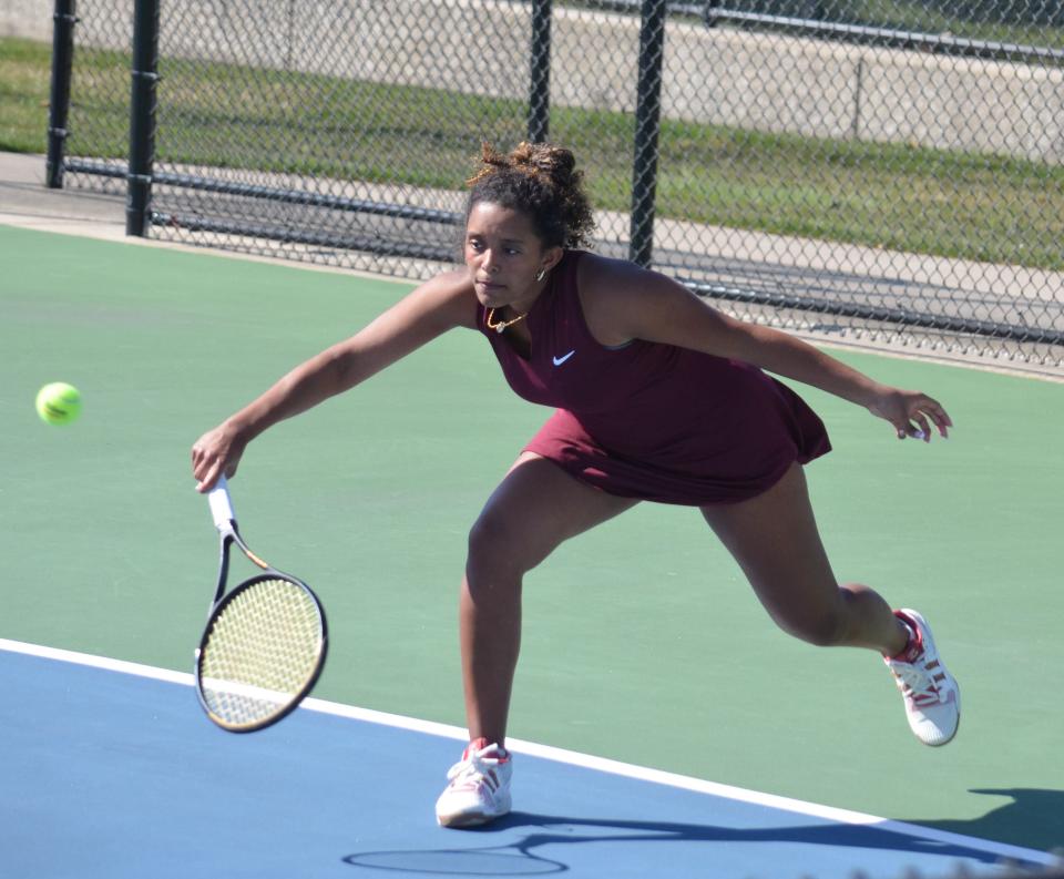 Holland Christian's Monika Diaz returns a shot at No. 2 singles against Holland on Tuesday at Holland Christian.