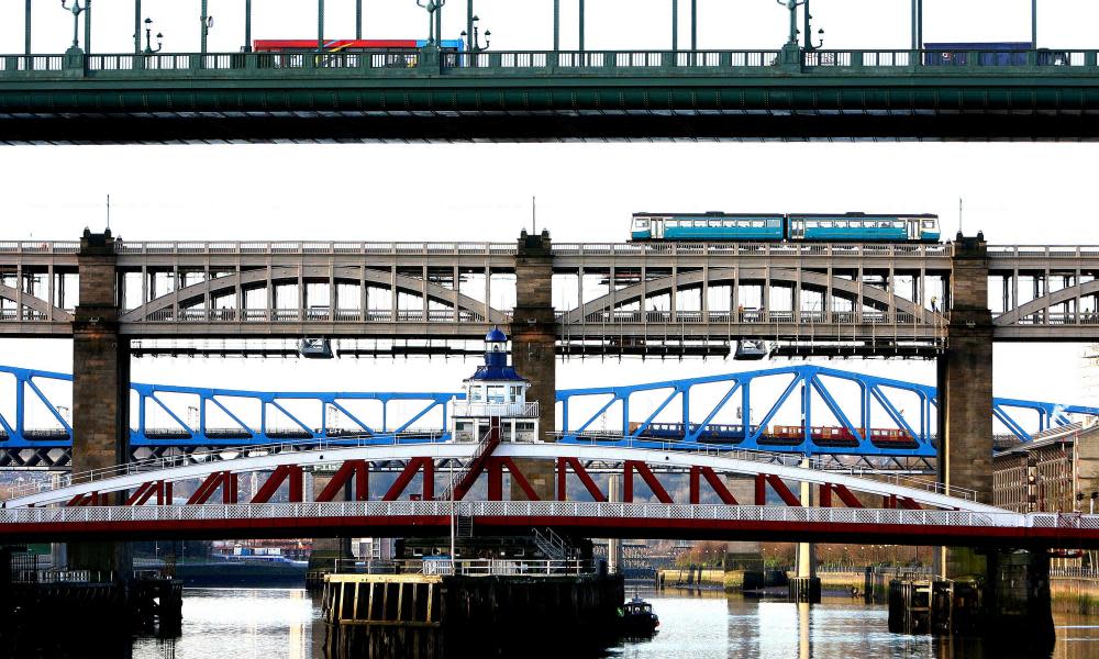 Trains and a bus cross the River Tyne in Newcastle