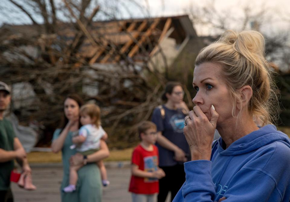 Kristie Wofford looks at the damage after a tornado heavily damaged several homes on Oxford Drive in Round Rock, Texas, on Monday (AP)