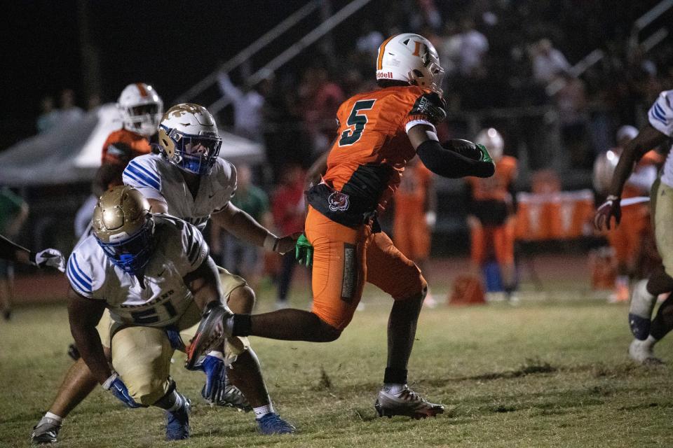 Shawn Russ of Dunbar gets a pick six against Daytona Beach's Mainland High School in the state football semifinal game on Friday, Dec. 2, 2022, in Fort Myers.