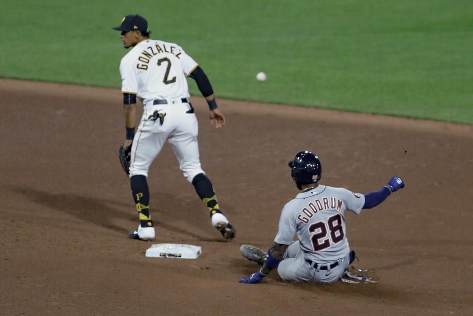 Detroit Tigers' Niko Goodrum (28) slides into second with an RBI double as the throw from Pittsburgh Pirates center fielder Cole Tucker heads to second baseman Erik Gonzalez (2) in the seventh inning of a baseball game, Friday, Aug. 7, 2020, in Pittsburgh. The hit drove in two runs. (AP Photo/Keith Srakocic)