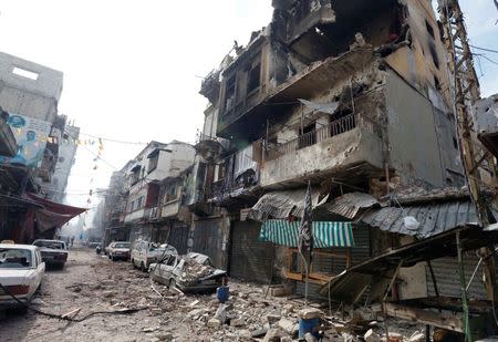 A views shows damaged buildings and vehicles following clashes between Lebanese soldiers and Islamist gunmen in Tripoli, northern Lebanon October 27, 2014. REUTERS/Mohamed Azakir