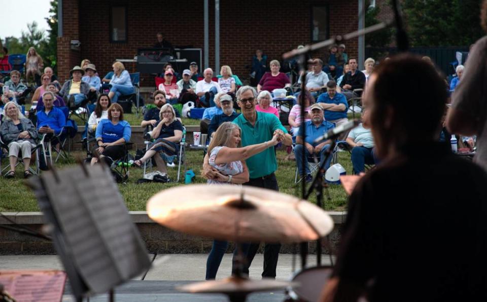 Dance partners Cindy Hellinger and David Lorio spin around in front of the stage to a number performed by The DiMartino-Osland Jazz Orchestra during the weekly Big Band and Jazz performance at the MoonDance Amphitheater in Lexington, Ky., on June 1, 2021.