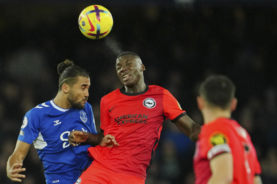 Everton's Dominic Calvert-Lewin, left, goes up against Brighton's Moises Caicedo, center, during the English Premier League soccer match between Everton and Brighton and Hove Albion at Goodison Park Stadium in Liverpool, England, Tuesday, Jan. 3, 2023. (AP Photo/Jon Super)