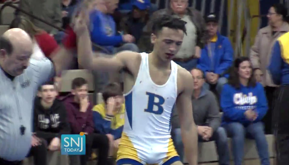 In this image taken from a Wednesday, Dec. 19, 2018 video provided by SNJTODAY.COM, Buena Regional High School wrestler Andrew Johnson is declared the winner after his match in in Buena, N.J. Before the match a referee told Johnson he would forfeit his bout if he didn't have his dreadlocks cut off. Johnson had his hair cut minutes before the match and a SNJ Today reporter tweeted video of the incident. The state's Interscholastic Athletic Association says they are recommending the referee not be assigned to any event until the matter has been reviewed more thoroughly. (Michael Frankel/SNJTODAY.COM viavAP)