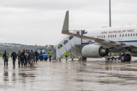 In this photo released by Australian Department of Defense, Australian Federal Police Special Operations members prepare to depart Canberra, Australia, for the Solomon Islands on a Royal Australian Air Force jet, Thursday, Nov. 25, 2021. Australia says it is sending police, troops and diplomats to the Solomon Islands to help after anti-government demonstrators defied lockdown orders and took to the streets for a second day in violent protests. (LACW Jacqueline Forrester/Australian Department of Defense via AP)