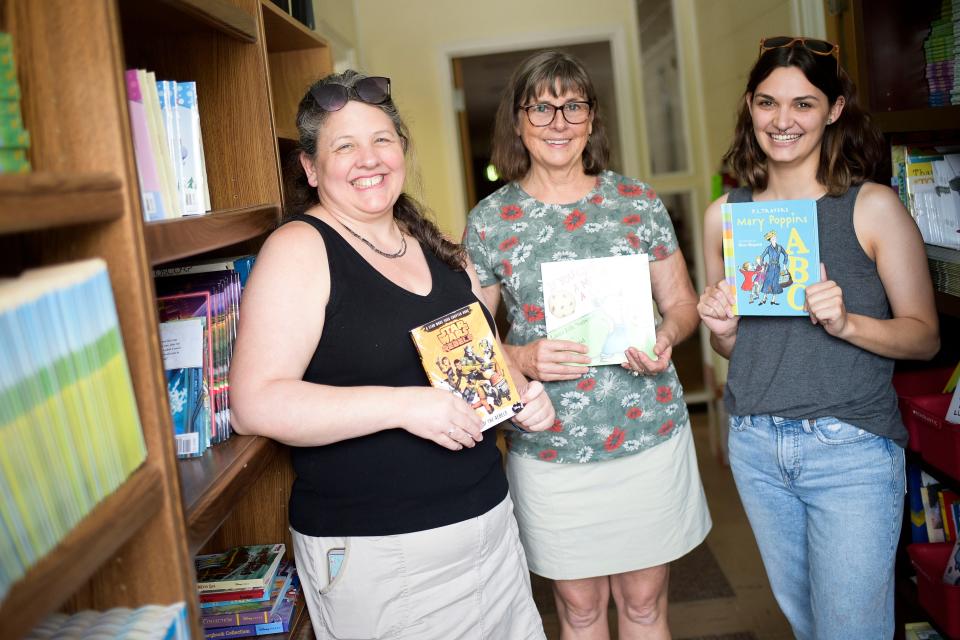 From left, Kristin Yarnell, Program Director, Teresa Brittain, Executive Director, and Program Assistant Sam Kistner pose for a portrait together at the Friends of Literacy office at 4630 Holston Drive in Knoxville, Tenn. on Friday, Aug. 12, 2022. The organization provides family literacy services focusing on providing books for the home and resources for parents to help their children become better readers.