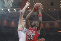 FILE - Chicago Bulls' Michael Jordan, right, goes to the hoop next to Philadelphia 76ers' Mike Gminski during second quarter of an NBA basketball game on March 1, 1988, in Philadelphia. (AP Photo/Bill Cramer, File)