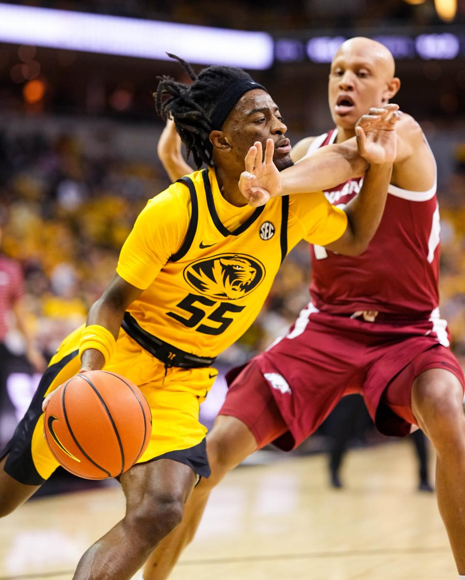 Missouri Tigers guard Sean East II (55) is fouled by Arkansas Razorbacks guard Jordan Walsh (13) during the first half at Mizzou Arena on Jan. 18, 2023 in Columbia, Missouri.