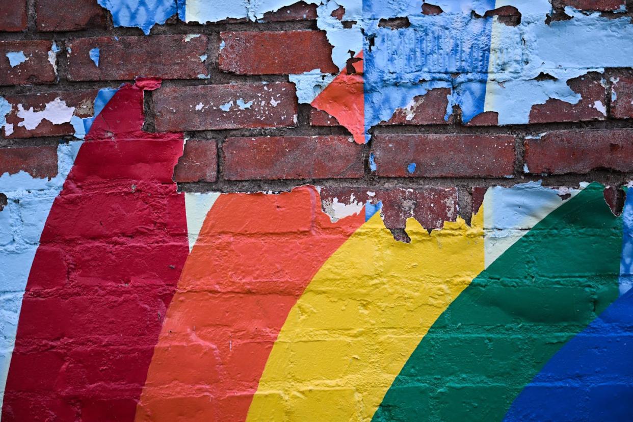 A painted rainbow peels off a wall in Laramie, Wyo., where nearly 26 years ago Matthew Shepard was killed. <a href="https://www.gettyimages.com/detail/news-photo/the-paint-of-a-rainbow-peels-off-a-brick-wall-in-downtown-news-photo/1243082916?searchscope=image%2Cfilm&adppopup=true" rel="nofollow noopener" target="_blank" data-ylk="slk:Patrick T. Fallon/AFP via Getty Images);elm:context_link;itc:0;sec:content-canvas" class="link ">Patrick T. Fallon/AFP via Getty Images)</a>