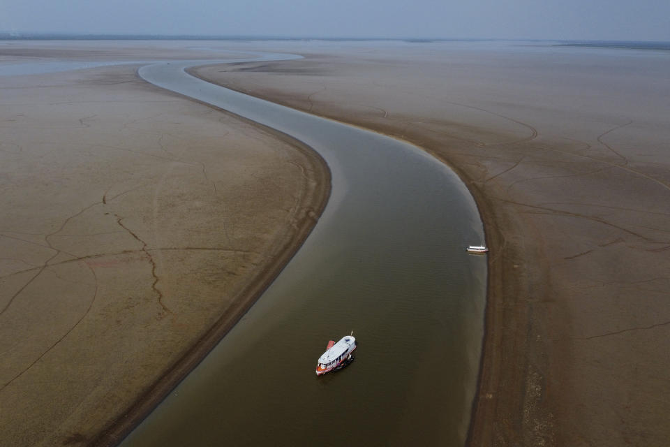 A ferry boat travels through a section of the Amazon River affected by a severe drought, near Manacapuru, Brazil, Sept. 27, 2023. (AP Photo/Edmar Barros)