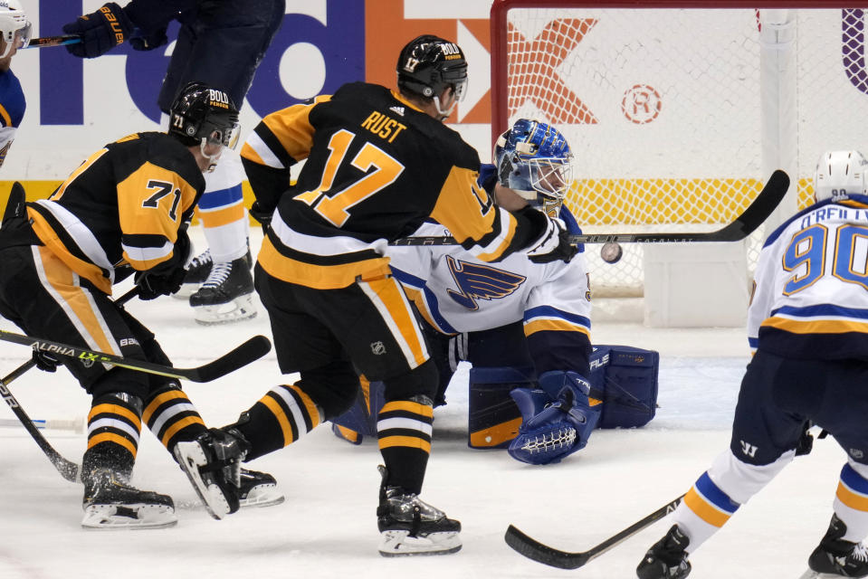 Pittsburgh Penguins' Bryan Rust (17) scores past St. Louis Blues goaltender Jordan Binnington during the first period of an NHL hockey game in Pittsburgh, Saturday, Dec. 3, 2022. (AP Photo/Gene J. Puskar)