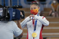 Guan Chenchen, of China, reacts after winning the gold medal on the balance beam during the artistic gymnastics women's apparatus final at the 2020 Summer Olympics, Tuesday, Aug. 3, 2021, in Tokyo, Japan. (AP Photo/Gregory Bull)