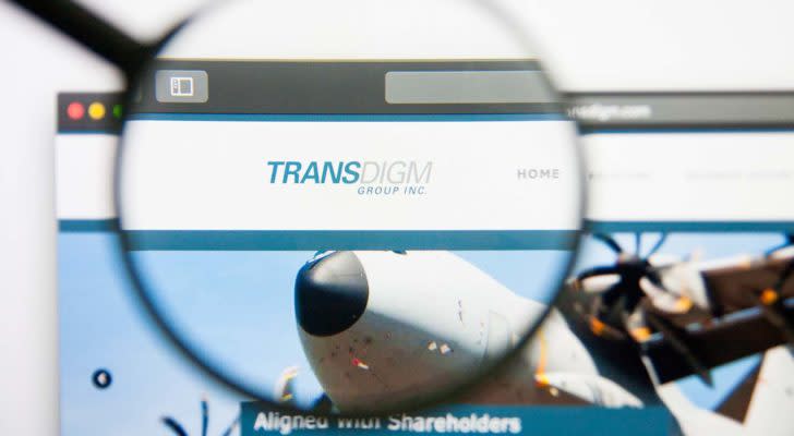 A magnifying glass zooms in on the TransDigm Group, Inc. (TDG) logo on their webpage