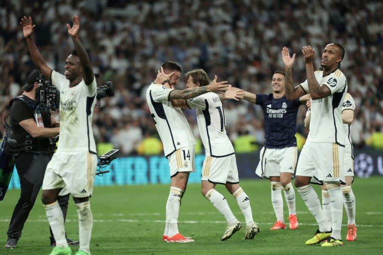 Joselu (C) celebrates with team-mates after his goals in the 88th and 91st minutes gave <a class="link " href="https://sports.yahoo.com/soccer/teams/real-madrid/" data-i13n="sec:content-canvas;subsec:anchor_text;elm:context_link" data-ylk="slk:Real Madrid;sec:content-canvas;subsec:anchor_text;elm:context_link;itc:0">Real Madrid</a> a stunning 2-1 comeback win over <a class="link " href="https://sports.yahoo.com/soccer/teams/bayern-munich/" data-i13n="sec:content-canvas;subsec:anchor_text;elm:context_link" data-ylk="slk:Bayern Munich;sec:content-canvas;subsec:anchor_text;elm:context_link;itc:0">Bayern Munich</a> to qualify for the Champions League final (Thomas COEX)