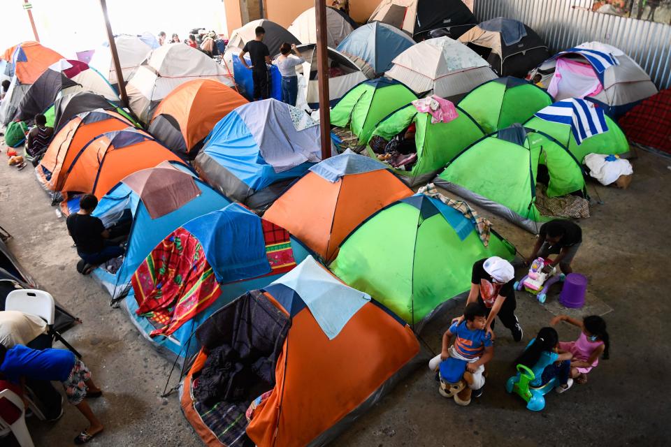 Children play as families live in tents at the Movimiento Juventud 2000 shelter with refugee migrants from Central and South American countries including Honduras and Haiti seeking asylum in the United States, as Title 42 and Remain In Mexico border restrictions continue, in Tijuana, Baja California state, Mexico on April 9, 2022.