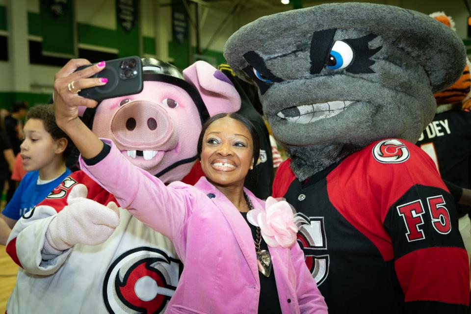 Cincinnati City Councilwoman Meeka Owens takes a selfie with Cincinnati Cyclones mascots during the Saturday Hoops program's Citywide Knockout Tournament held at Cincinnati State on March 9, 2024. Saturday Hoops is celebrating its 20th anniversary all year long.