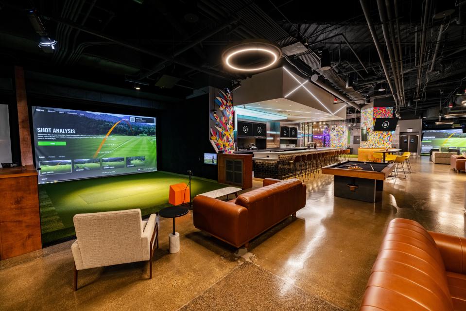 The interior of a Chicago location of Five Iron Golf. The company, founded in New York City in 2017, offers food and beverage alongside indoor golf simulators.
