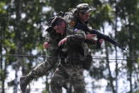 <p>Servicemen of the Russian Armed Forces during the Scout Trail obstacle course, a stage of the Army Scout Masters competition among reconnaissance units, as part of the 2018 International Army Games at the Koltsovo range in Novosibirsk region, Russia on Aug. 2, 2018. (Photo: Kirill Kukhmar/TASS via Getty Images) </p>