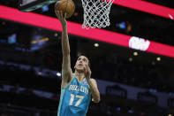 Charlotte Hornets forward Aleksej Pokusevski drives to the basket for a layup against the Oklahoma City Thunder during the first half of an NBA basketball game in Charlotte, N.C., Sunday, April 7, 2024. (AP Photo/Nell Redmond)
