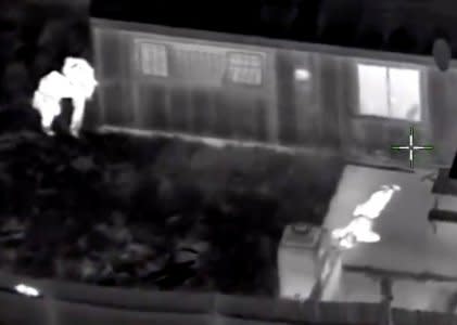 Stephon Clark, 22, is visible on the ground after two police officers (L) shot him, in this still image captured from police aerial video footage released by Sacramento Police Department, California, U.S., on March 21, 2018.   Courtesy Sacramento Police Department/Handout via REUTERS