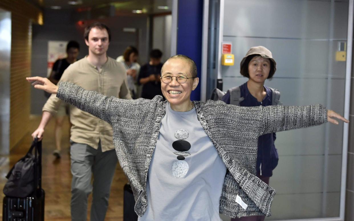 As Liu Xia arrived in Helsinki on her way to Berlin, she seemed buoyant about her departure from China and house arrest - AFP