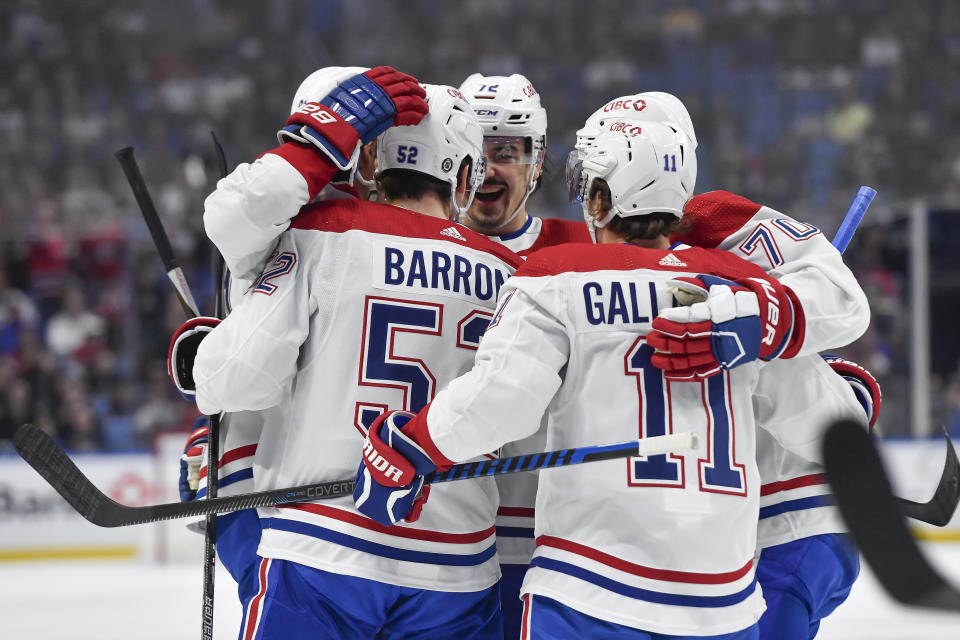 Montreal Canadiens defensemen Justin Barron and Arber Xhekaj (72) celebrate with right wing Brendan Gallagher (11) and left wing Tanner Pearson after scoring during the first period of an NHL hockey game against the Buffalo Sabres in Buffalo, N.Y., Monday, Oct. 23, 2023. (AP Photo/Adrian Kraus)