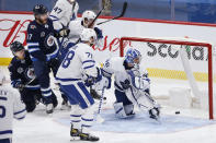 Winnipeg Jets' Mason Appleton (22) scores against Toronto Maple Leafs goaltender Jack Campbell (36) as Morgan Rielly (44) and TJ Brodie (78) defend during the second period of an NHL hockey game Friday, May 14, 2021, in Winnipeg, Manitoba. (John Woods/The Canadian Press via AP)