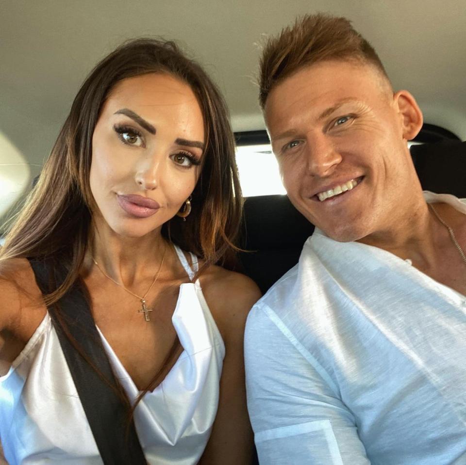 Lizzie Sobinoff and Seb Guilhaus pose for a selfie in a car