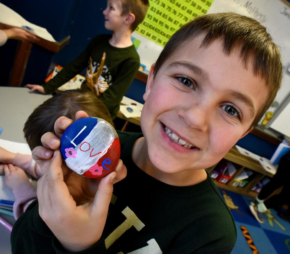 Dundee Elementary School first grader Jimmy Kerr is proud of the rock he painted for his teacher, Jenny Dolezal, who has been gone from the classroom for the past four weeks after being diagnosed with breast cancer. "The kids know she has been out sick," said literacy coach Emily Thompson, who created the idea for the students to surprise her friend Dolezal.