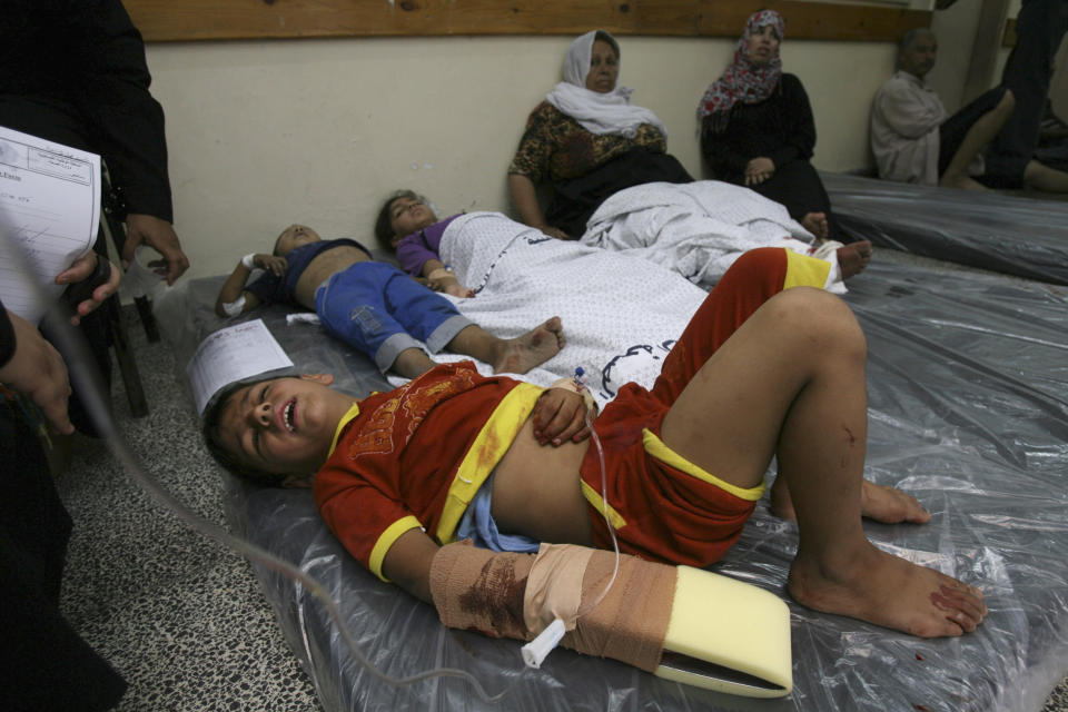 FILE - In this file photo dated Friday, Aug. 1, 2014, Wounded Palestinian children lie on mattresses spread on the floor of a hospital after Israeli shelling in Rafah in the southern Gaza Strip. The Israeli military said on Wednesday Aug. 15, 2018, its investigation focused on an Aug. 1, 2014, battle in the southern Gaza town of Rafah, one of the bloodiest incidents of the 2014 war in the Gaza Strip, has found no criminal wrongdoing by Israeli forces, although human rights advocates accused the military of a whitewash.(AP Photo/Eyad Baba, FILE)